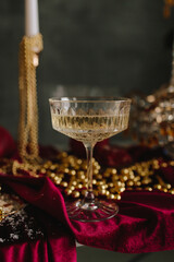 Holiday table scene with champagne glass and festive decorations.