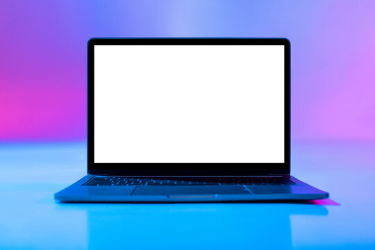 A sleek laptop is open and facing forward with a blank screen.