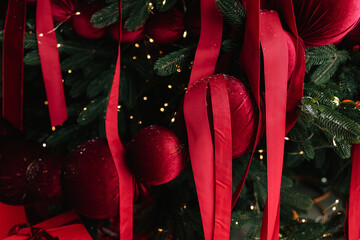 Festive decorating with placing baubles on Christmas tree.