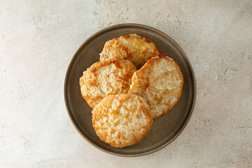 A top down view of a plate of turkey patties.