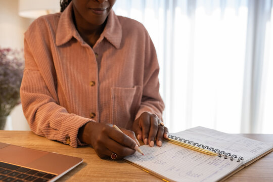 Confident woman budgeting at home office