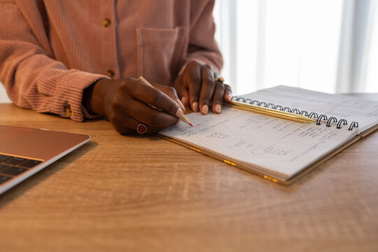 Woman highlighting numbers while counting budget