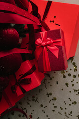 Holiday red gifts under Christmas tree with cozy festive vibes.