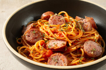 A view of a plate of gluten-free spaghetti and sausage.