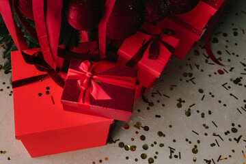 Christmas presents under tree with ribbons, bows, and ornaments.