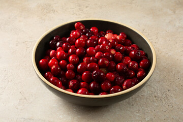 A view of a bowl of raw cranberries.
