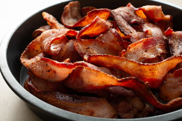 A view of a pan of thick cut bacon strips.