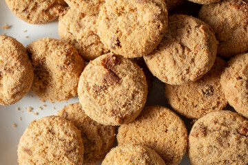A top down view of a pile of crunchy cookies chocolate chip, as a background.