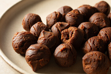 A closeup view of gluten-free, dairy-free chocolate peanut butter raspberry jam bites, on a plate.