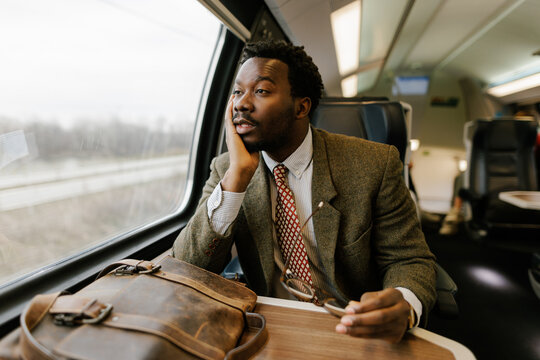 Tired Businessman Traveling by Train Sitting With a Briefcase