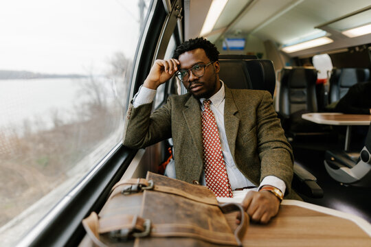 Man Traveling on a Train While Contemplating His Journey
