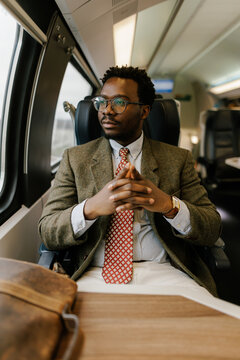 Portrait of Man in Suit Traveling on Train While Deep in Thought