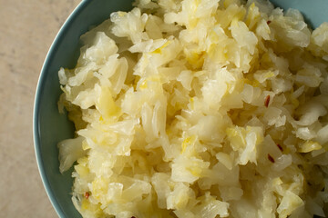 A top down view of a bowl of sauerkraut.