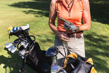 Senior Woman Selecting a Golf Club