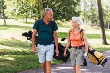 Senior Couple Walking Together on a Golf Course