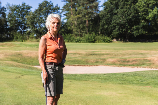 Senior Woman Standing on a Golf Course