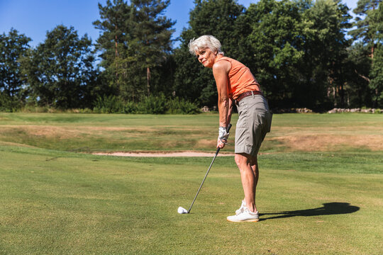 Senior Woman Concentrating on a Putt