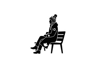 Silhouette of a Person Sitting on a Bench Wearing Winter Gear with Canadian Symbols