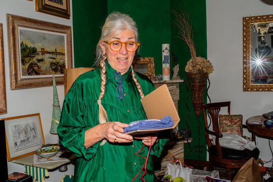Woman Unboxing a Surprise Gift in a Cozy Room Filled With Decor
