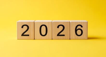 Wooden Blocks Forming 2026 Against Bright Yellow Background
