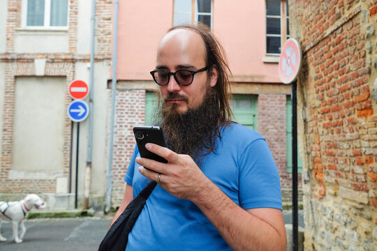 Man with beard using phone