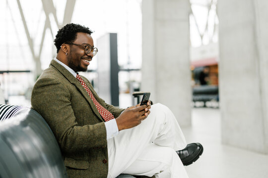 Young handsome man using smartphone at airport terminal