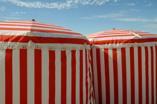 Red and White Striped Cabins at the Beach