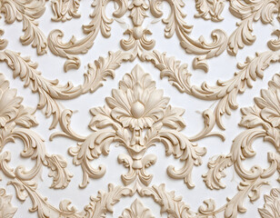 Detailed beige classical floral and scroll plasterwork on a white wall. An elegant, ornate background with intricate decorative molding.