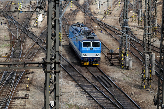 Blue train approaching on tracks