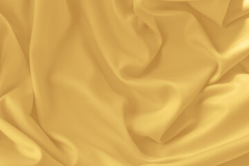 Gold silk fabric background with folds.Copy space.