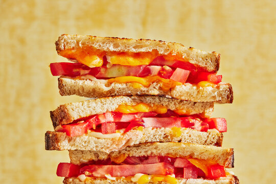 A Stack Of Tomato And Cheese Sandwhiches