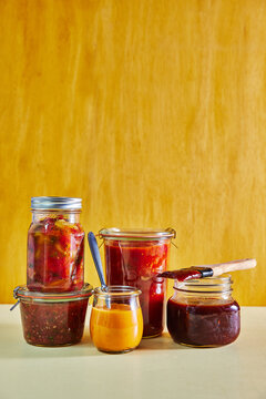 Assorted Homemade Sauces and Preserves in Glass Jars