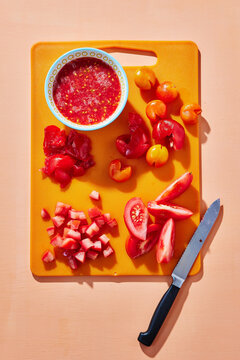 Fresh Chopped Tomatoes and Sauce on Cutting Board