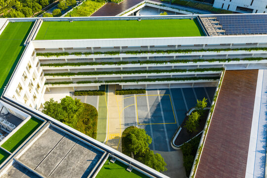 modern building rooftop with lawn and solar panels