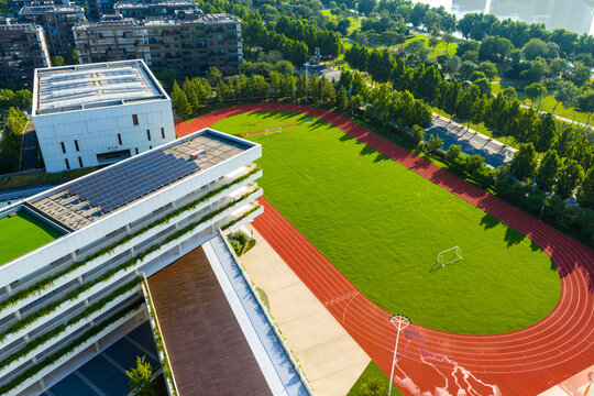 modern building rooftop with lawn, solar panels and public playground