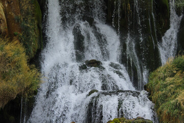 Editorial photo of the Kravice Waterfall in Herzegovina, captured on August 24, 2025, showing powerful cascading water over mossy rocks.