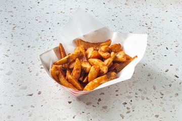A view of a tray of potato wedges.