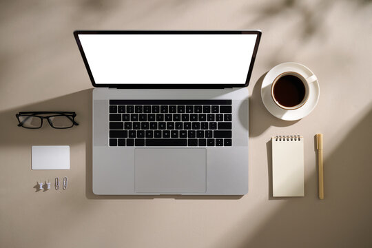 Modern workspace setup with a laptop, coffee, and workspace essentials