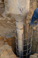Pouring concrete for a building foundation piling construction