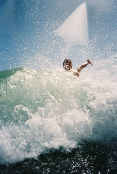 A person Catches a Big Wave on a Sunny Day