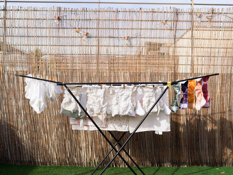 Clothes Drying on Rack in Sunlit Backyard Setting