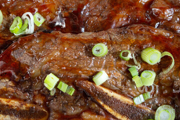 A top down view of a layer of short ribs, as a background.