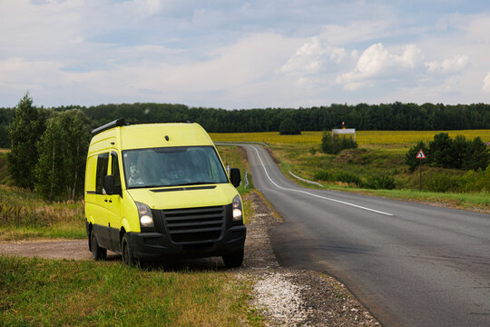 Van Parked Alongside Open Highway in Rural Landscape