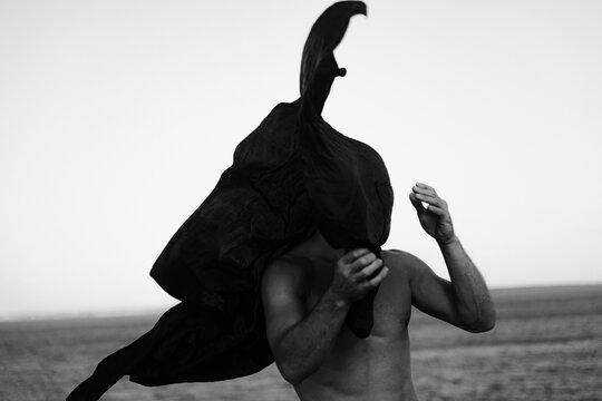 The Man Covers His Face With A Black Cloth