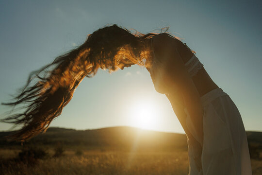 Sunset Hair in Windy Field During Golden Hour