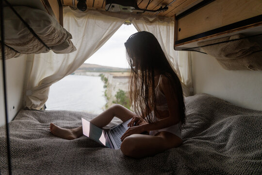 Working Remotely on Bed in a Cozy Camper Van