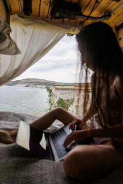 Working Remotely by the Ocean From a Cozy Van Interior