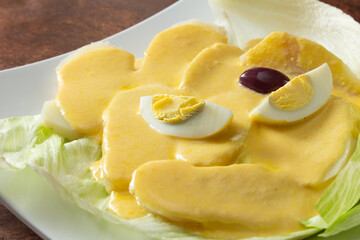 A closeup view of a plate of papa a la huancaina.