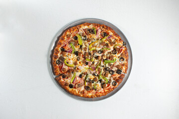 A top down view of a deluxe pizza.