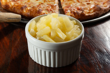 A view of a bowl of chopped pineapple.